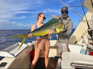 Angler holding a mahi-mahi caught on a Key West fishing charter